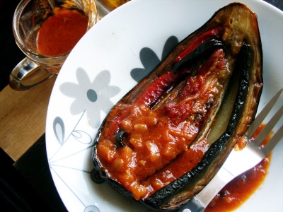 Stuffed Aubergine, with bacon, courgettes, red peppers and tomato sauce